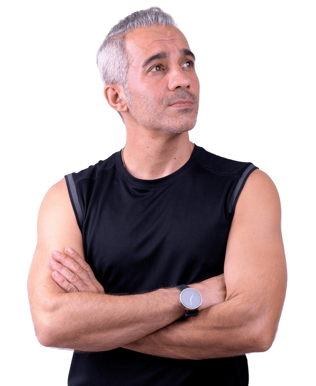 Confident middle-aged man with gray hair and athletic build standing with arms crossed, representing healthy aging, fitness, and wellness lifestyle